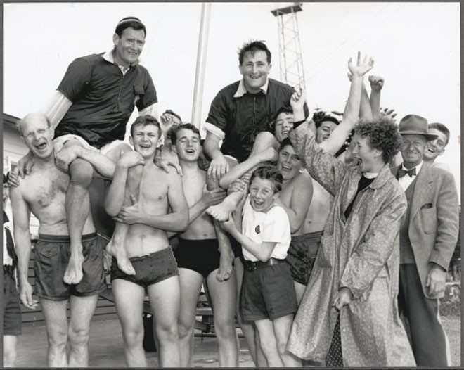 Members of the 9th St Kilda-Elwood Sea Scouts chair the Australian pair of Rolly Tasker and Malcolm Scott after their win on the first day of the 12 sq. m. Sharpie Class, Olympic Games, Port Phillip Bay, Victoria, 1956 - Australian sailing legend Rolly Tasker sails away © Bruce Howard